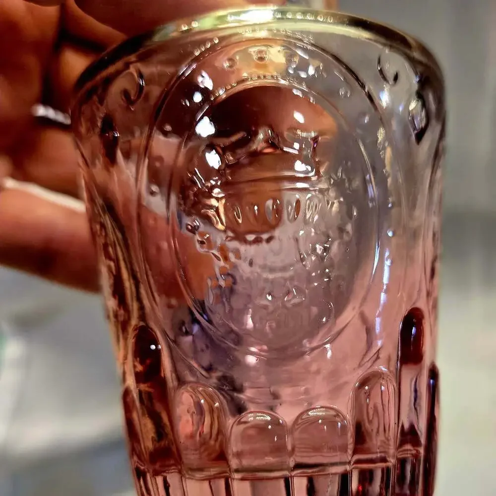 Vintage Pressed Pink Glass Bitters Bottle with Embossed Crest and Fluted Base